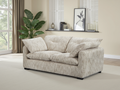 Beige sofa in a living room with a plant and decorative items.