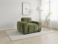 Green armchair in a modern living room with a lamp and small table.