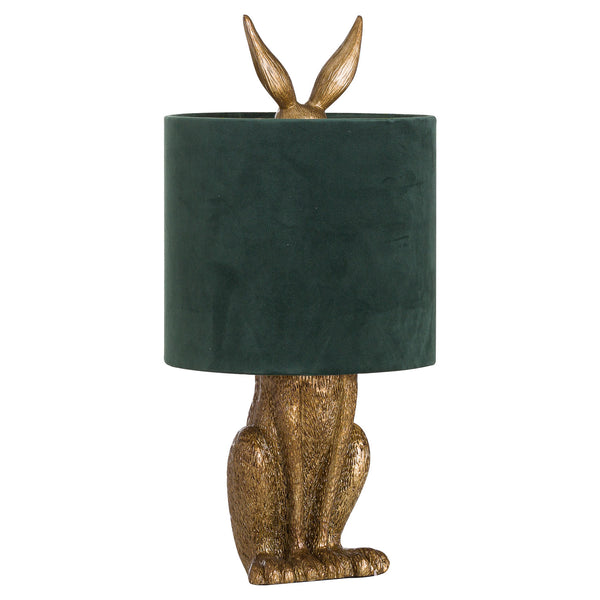 Decorative table lamp with gold rabbit body and green lampshade on a white background