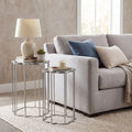 Gray sofa with decorative pillows and side tables in a living room setting