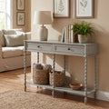 Gray console table in a living room with decor items