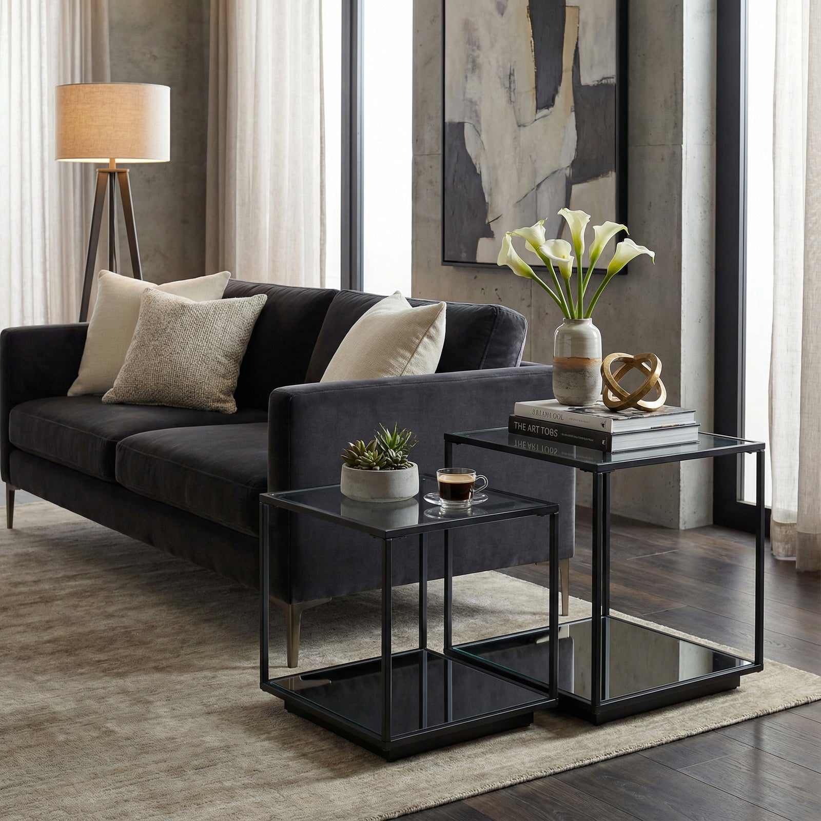 Modern living room with a gray sofa, side tables, and decorative items.
