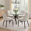 Dining room with a round glass table and four gray chairs.