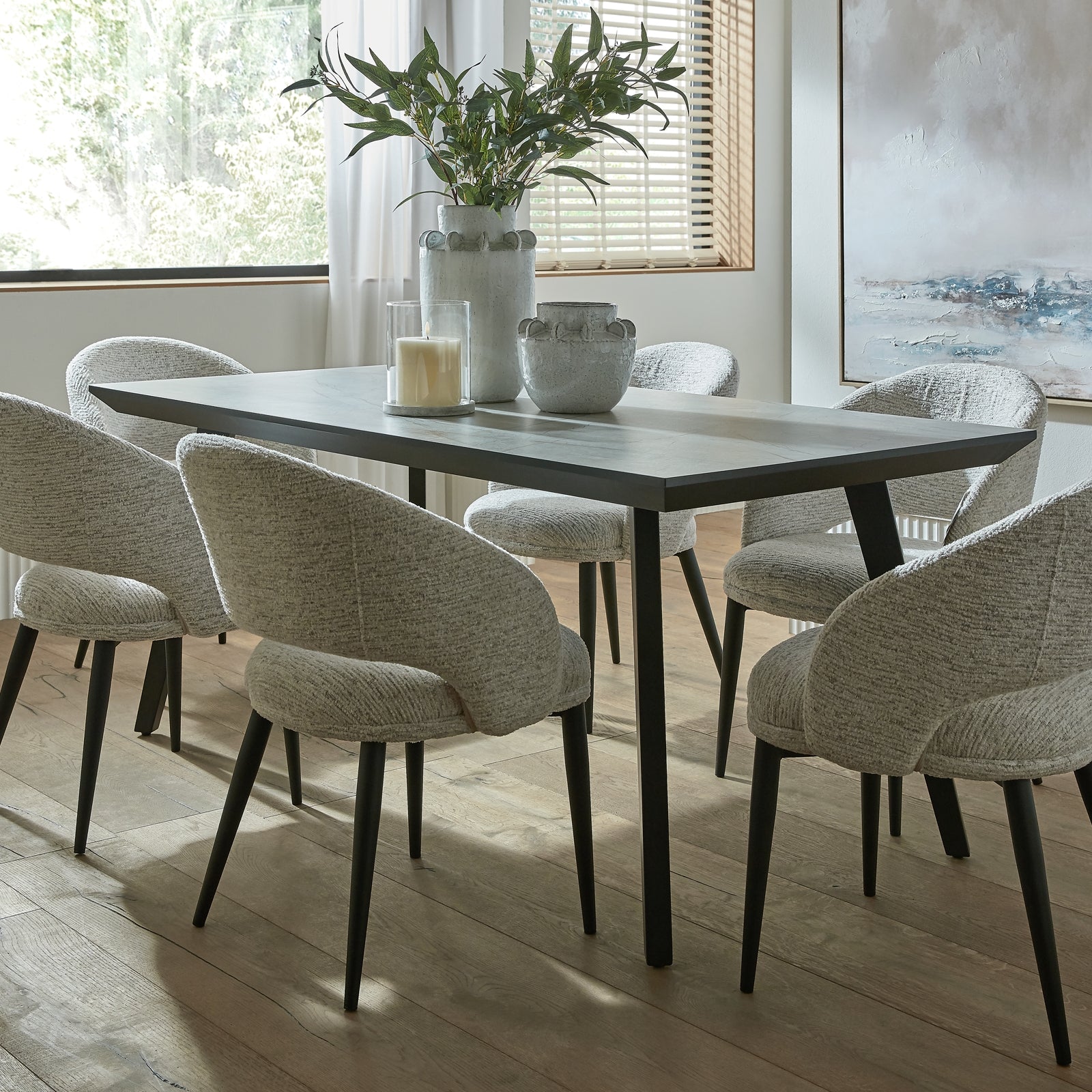 Dining room with a table and chairs in a well-lit room.