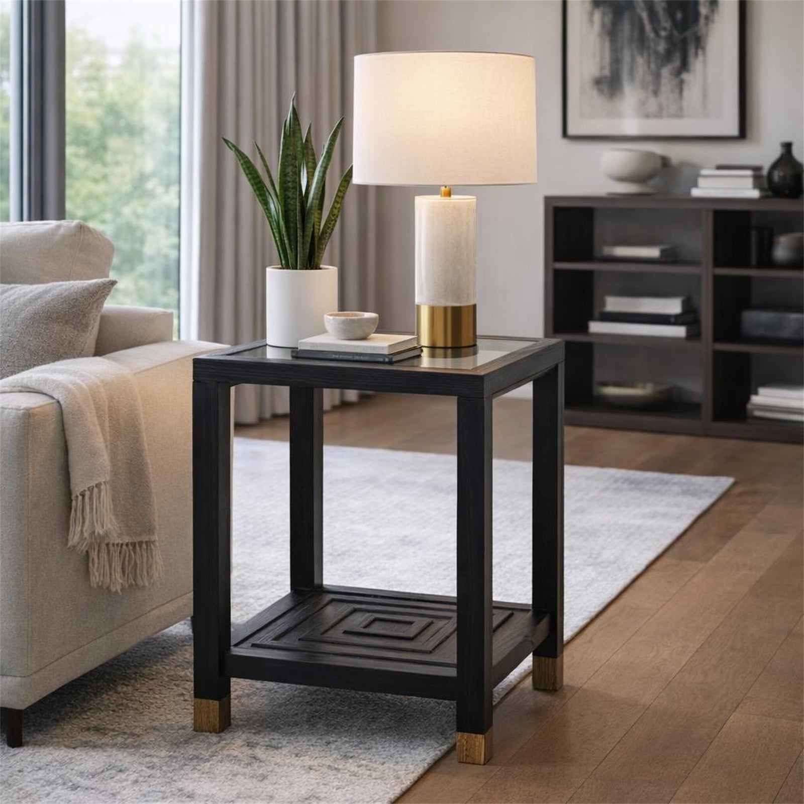 Black side table with a lamp and plant in a living room setting