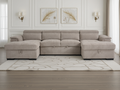 Beige sectional sofa in a living room with decorative wall art and rug.