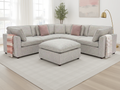 Gray sectional sofa with pink cushions in a living room setting.
