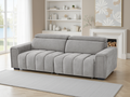 Gray sofa in a living room with a fireplace and shelves.