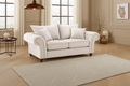 White sofa in a living room with a rug and decorative items.
