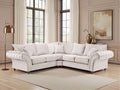 White sectional sofa in a living room with large windows and decorative elements.