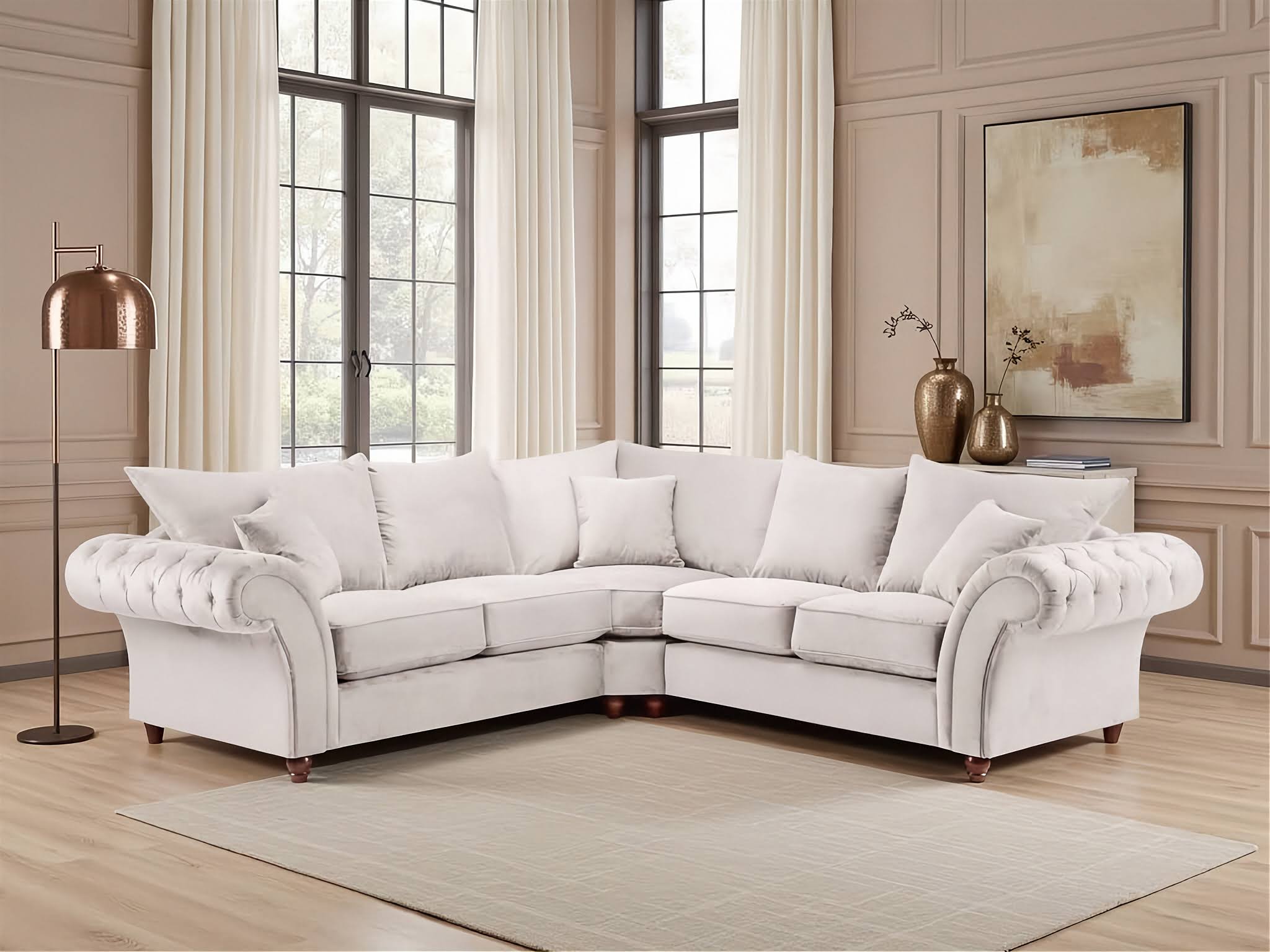 White sectional sofa in a living room with large windows and decorative elements.