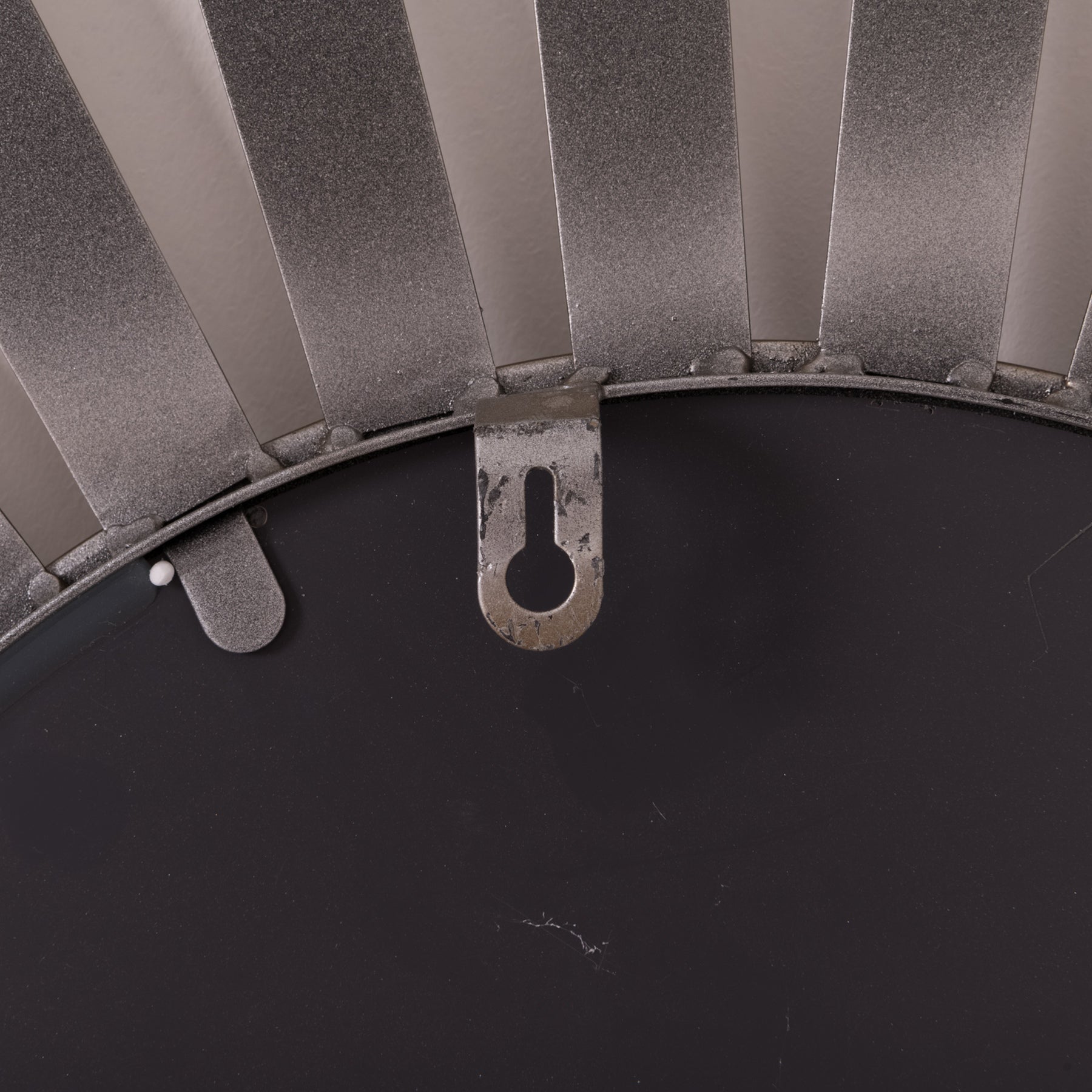 Close-up of a metal fan blade on a black background